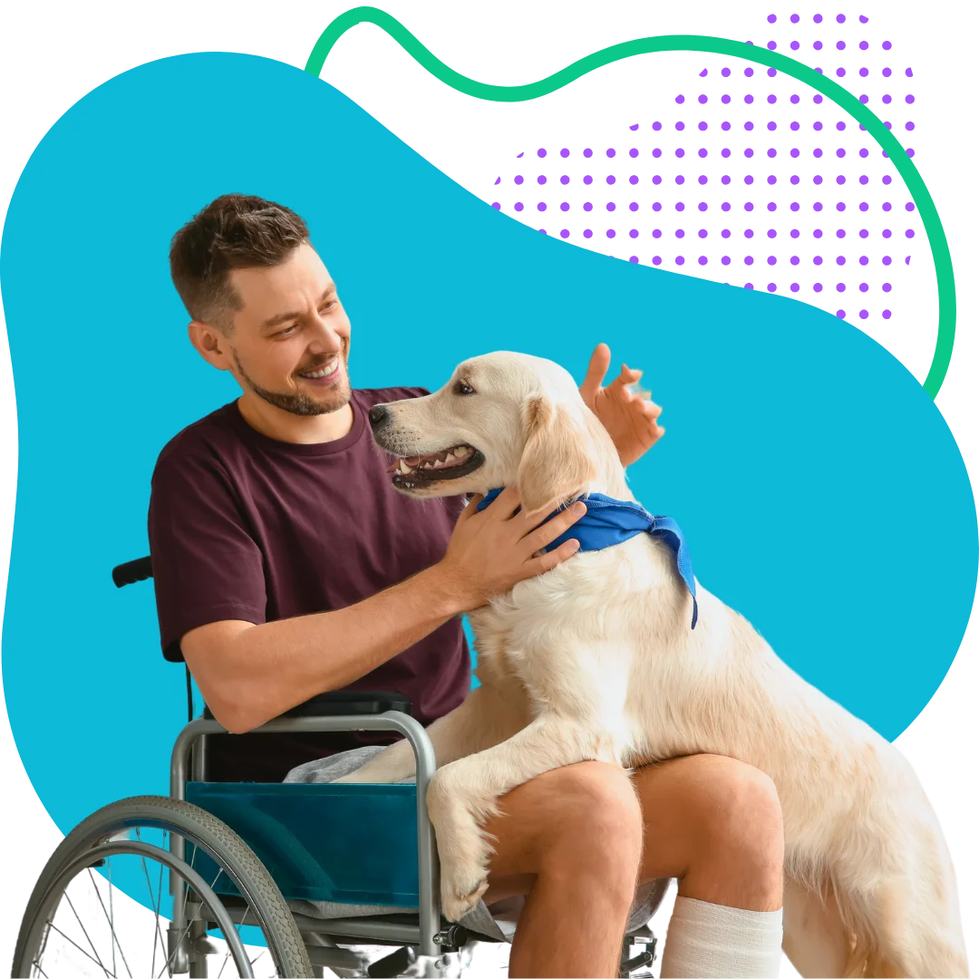 man in a wheelchair with his dog on his lap with a colorful abstract background