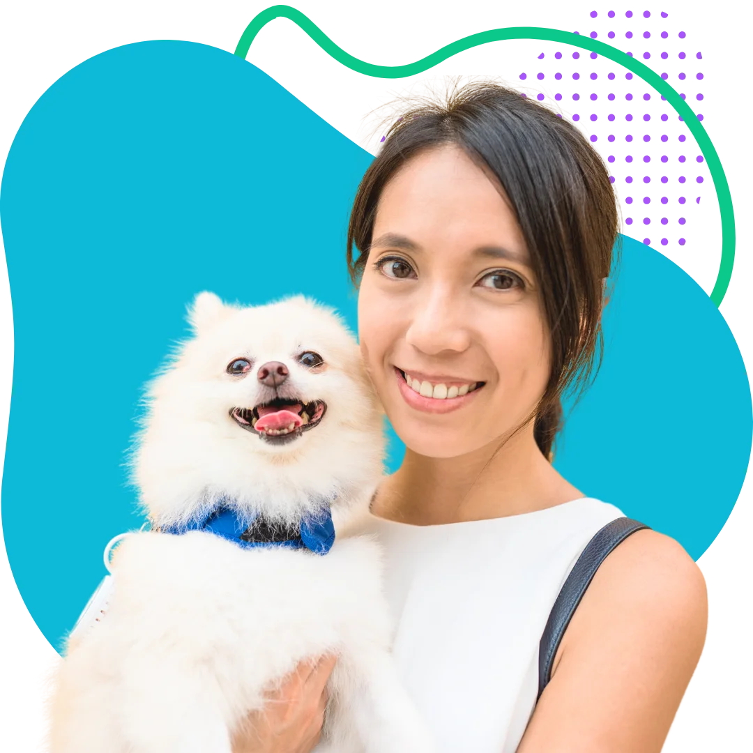 woman holding her small fluffy white dog smiling with a colorful abstract background